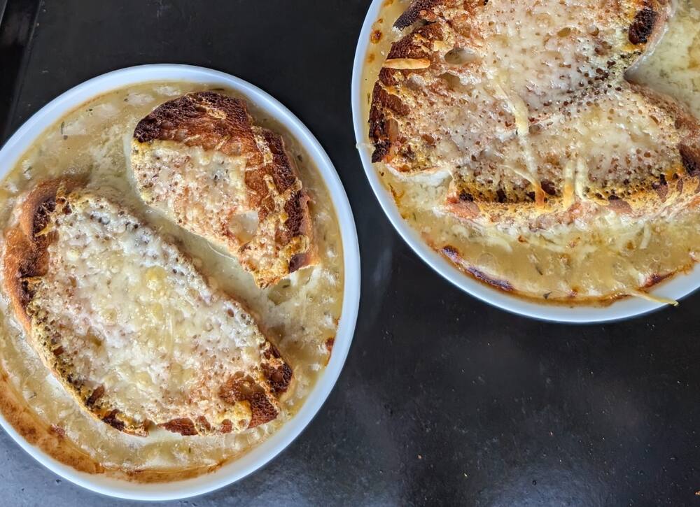 Two dishes of onion soup gratinated under bread and melted cheese